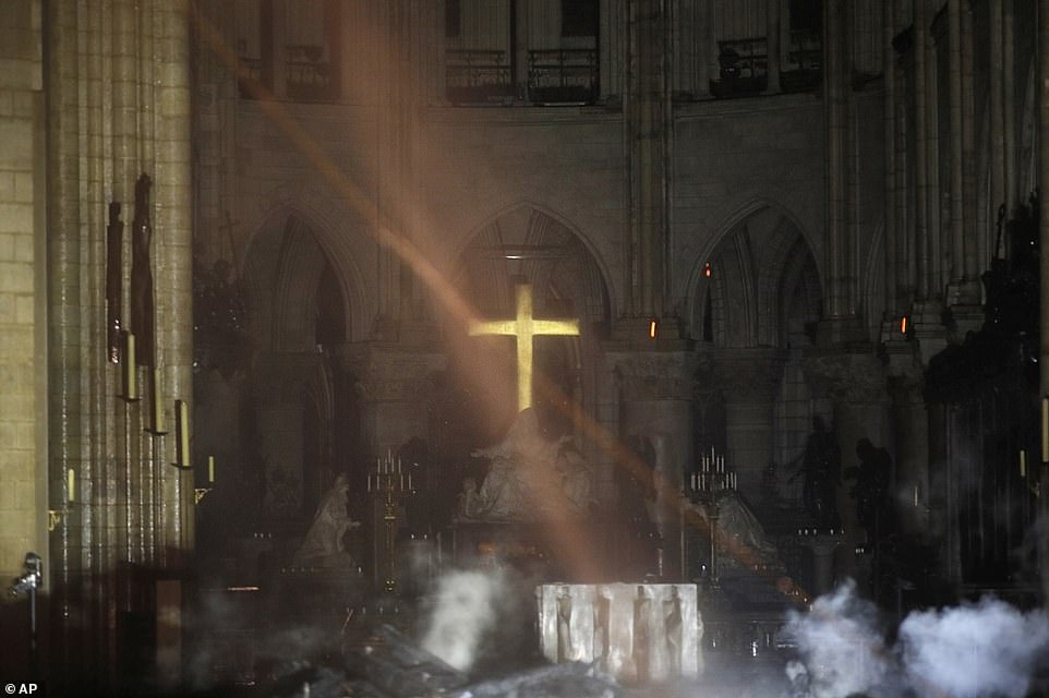 12319346-6925015-Smoke_is_seen_around_the_alter_inside_Notre_Dame_cathedral_on_Mo-a-17_1555377330376